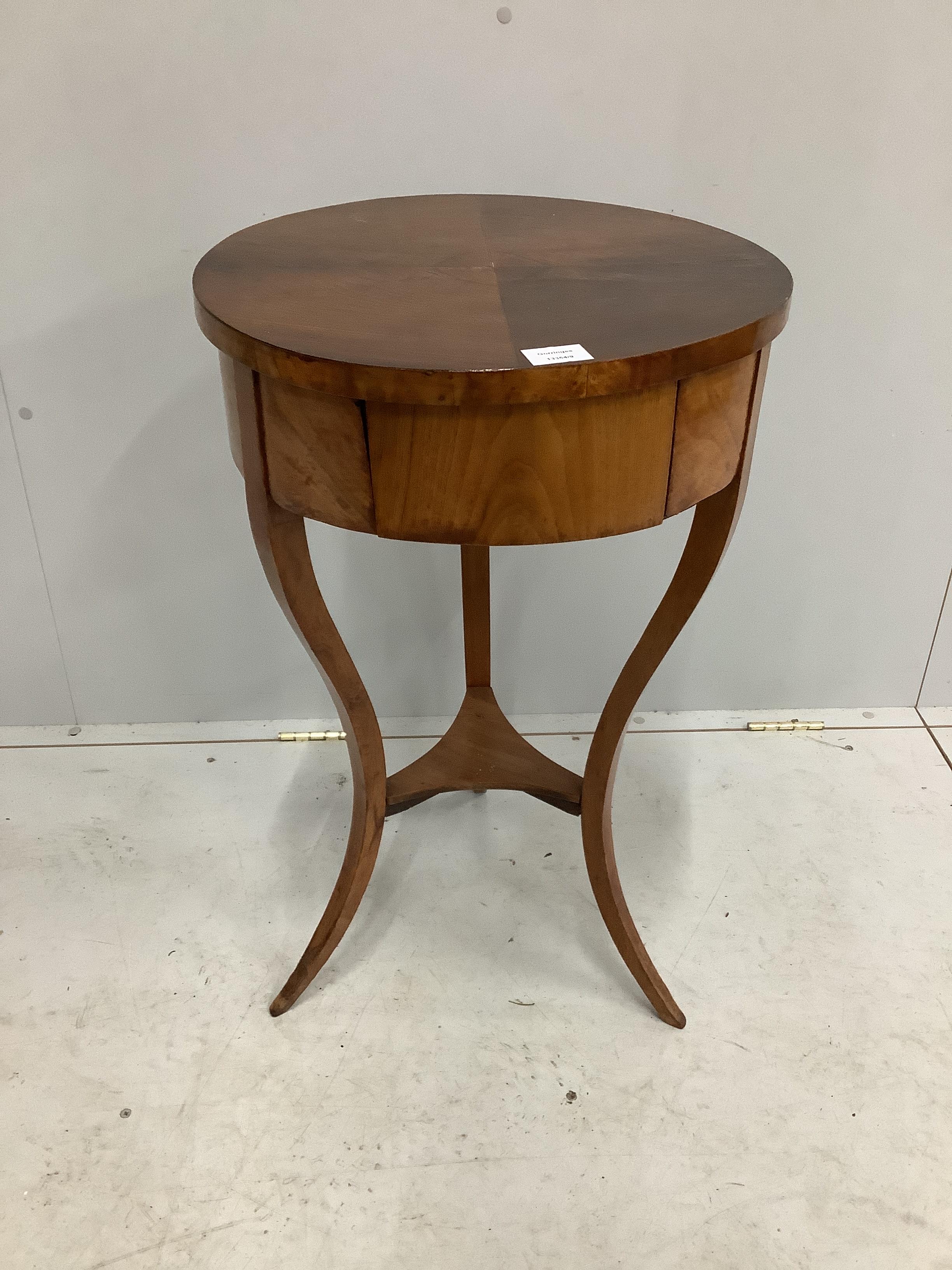 A 19th century Biedermeier mahogany circular work table, diameter 46cm, height 75cm